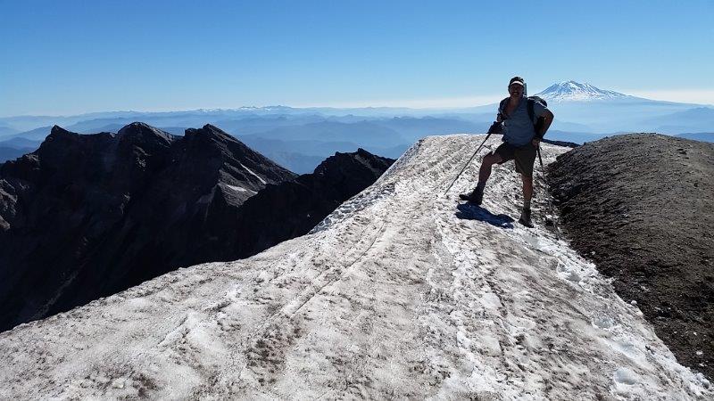 Carew_on_summit_of_Mt._St._Helens_with_Mt._Adams_in_the_background[1]